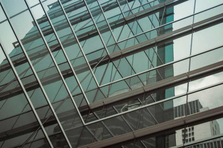 Glasfassade eines modernen Gebäudes, reflektiert die nachhaltige Planung und Beratung durch PB-TGA GmbH